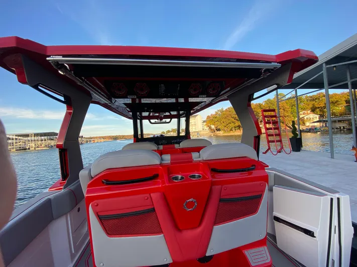  Yacht Photos Pics 2024 Fountain 38 SCX boat with red and white interior, docked by the water.