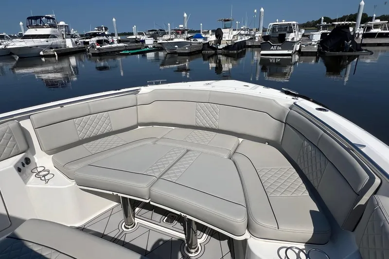  Yacht Photos Pics 2024 Pursuit S 328 Sport boat interior with luxurious seating at marina.