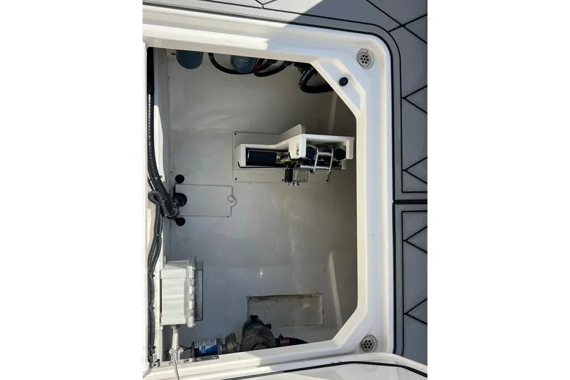  Yacht Photos Pics 2024 Pursuit S 328 Sport boat storage compartment with visible wiring and equipment.