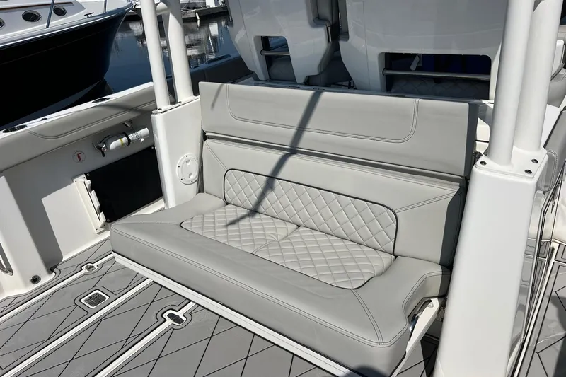  Yacht Photos Pics 2024 Pursuit S 328 Sport boat with luxurious gray seating and diamond-patterned upholstery.