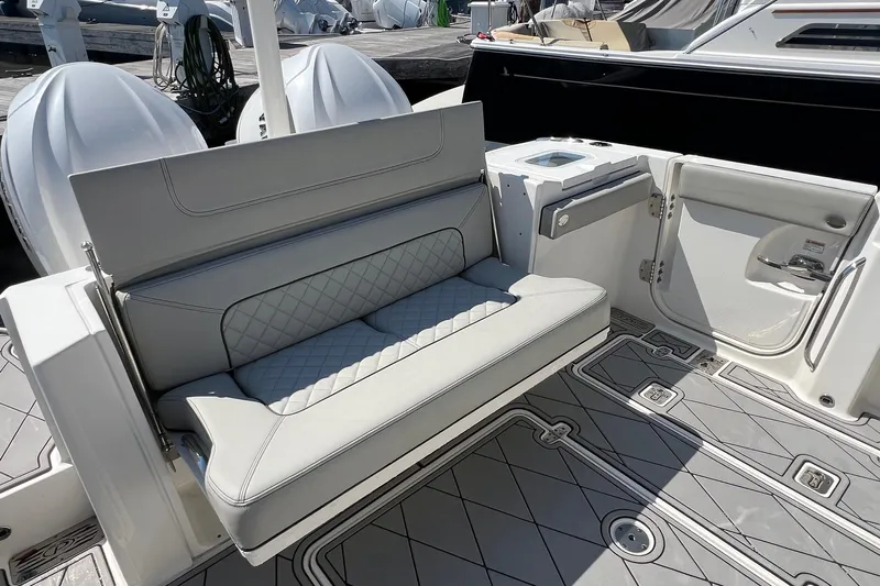  Yacht Photos Pics 2024 Pursuit S 328 Sport boat interior with cushioned seating and sleek design.