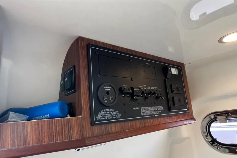  Yacht Photos Pics 2024 Pursuit S 328 Sport control panel with wood finish and electrical switches.