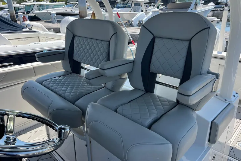  Yacht Photos Pics 2024 Pursuit S 328 Sport boat seats with quilted design and armrests.