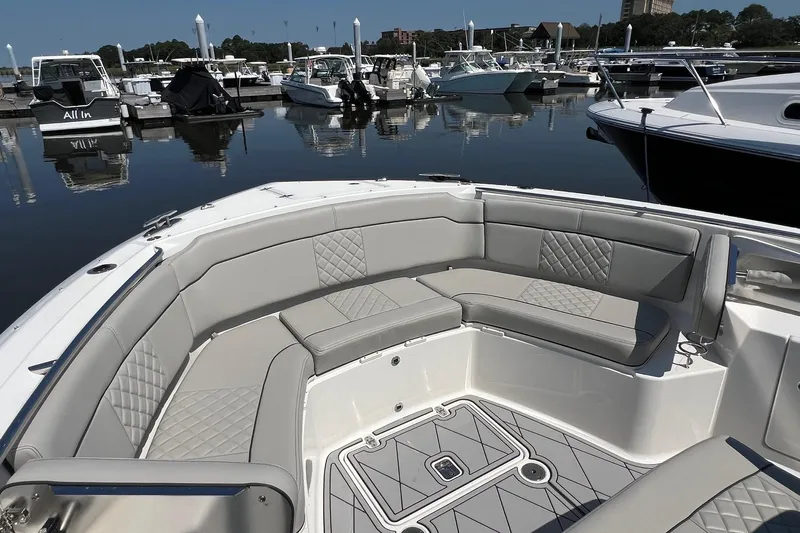  Yacht Photos Pics 2024 Pursuit S 328 Sport boat with luxurious seating at a marina.