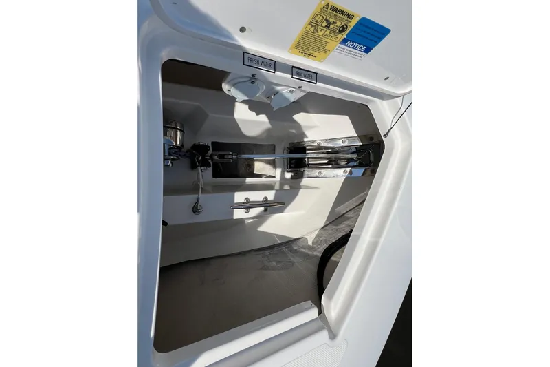  Yacht Photos Pics 2024 Pursuit S 328 Sport boat compartment with fresh and raw water labels.