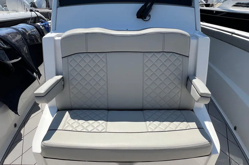  Yacht Photos Pics 2024 Pursuit S 328 Sport boat seat with diamond-stitched upholstery and armrests.
