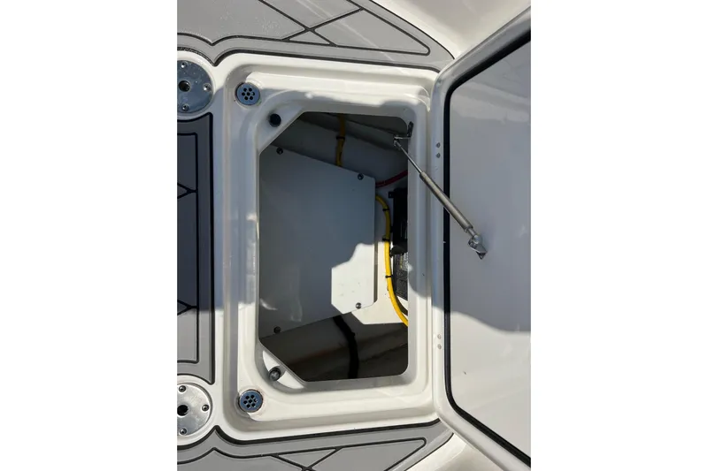  Yacht Photos Pics 2024 Pursuit S 328 Sport boat storage compartment with open hatch and visible wiring.