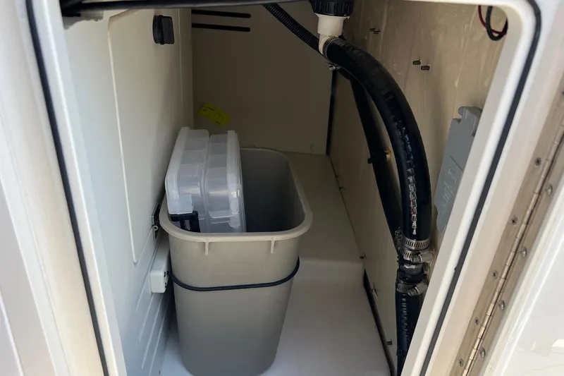 Yacht Photos Pics 2024 Pursuit S 328 Sport storage compartment with container and hose.