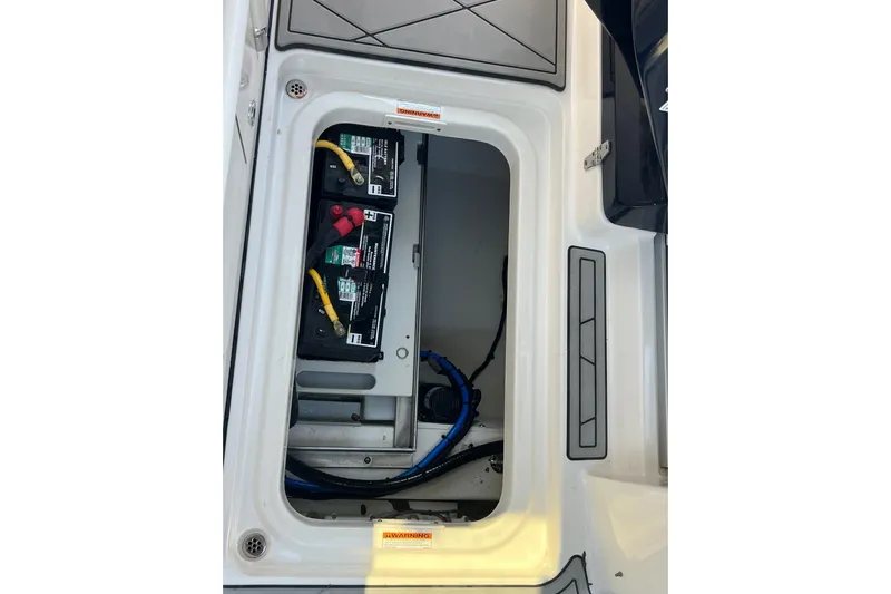  Yacht Photos Pics 2024 Pursuit S 328 Sport boat battery compartment with dual batteries and wiring.