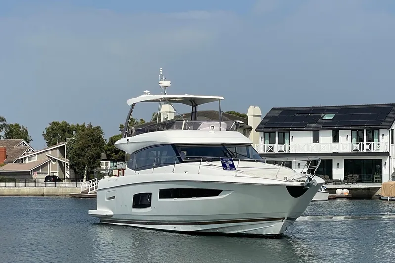 " La Bella Vita" Yacht Photos Pics 2017 Prestige 560 Flybridge yacht docked near waterfront homes.
