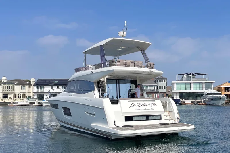 " La Bella Vita" Yacht Photos Pics 2017 Prestige 560 Flybridge yacht docked in a scenic marina setting.