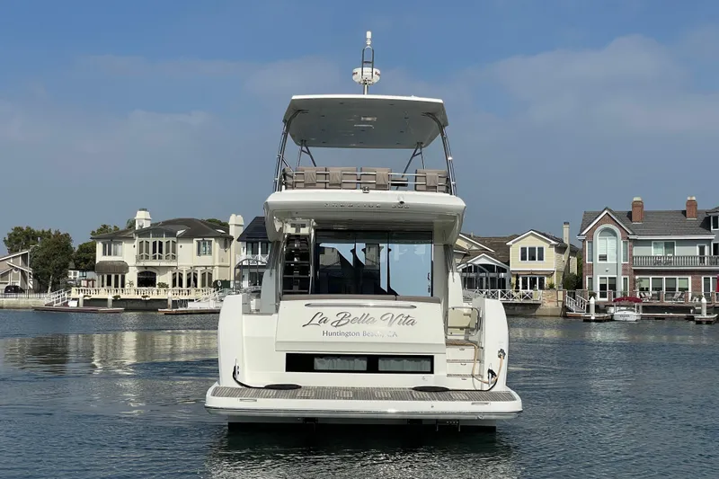 " La Bella Vita" Yacht Photos Pics Prestige 560 Flybridge yacht, 2017 model, docked near waterfront homes.