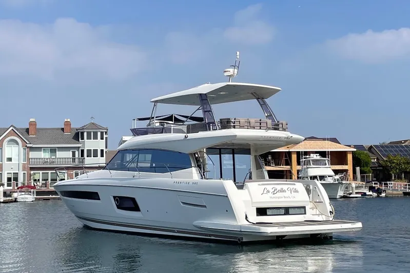 " La Bella Vita" Yacht Photos Pics 2017 Prestige 560 Flybridge yacht docked near waterfront homes.
