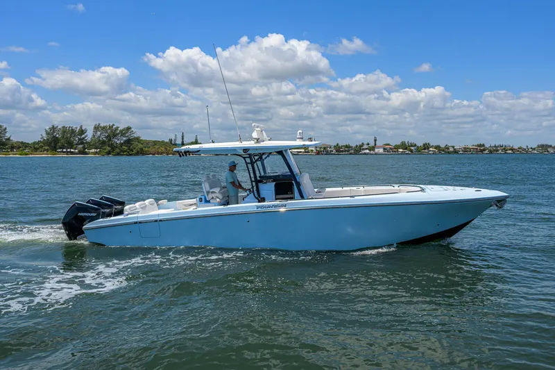  Yacht Photos Pics 2022 Fountain 34 CC boat cruising on a sunny day with clear skies.