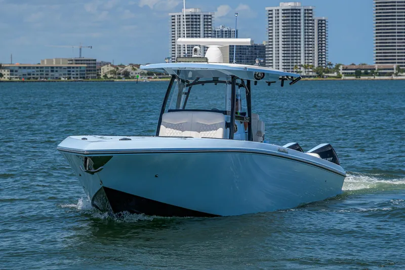  Yacht Photos Pics 2022 Fountain 34 CC boat cruising on water with city skyline in background.