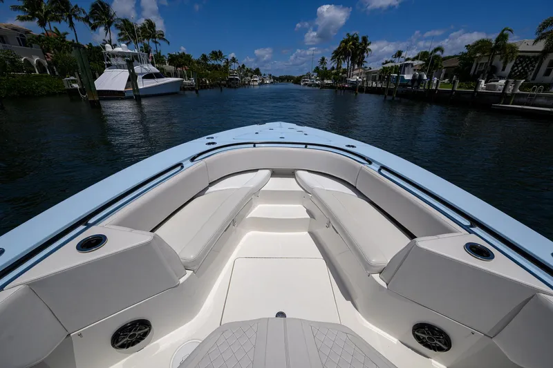  Yacht Photos Pics 2022 Fountain 34 CC boat with spacious seating, cruising on a scenic waterway.