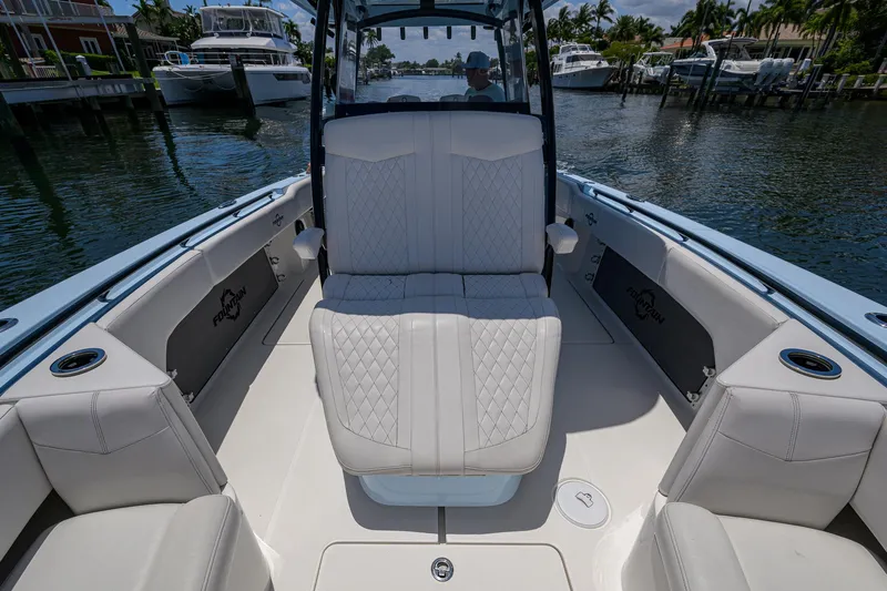  Yacht Photos Pics 2022 Fountain 34 CC boat interior with luxurious seating and waterfront view.