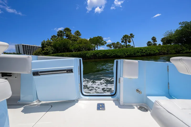  Yacht Photos Pics 2022 Fountain 34 CC boat interior with open door, scenic water view, and clear blue sky.