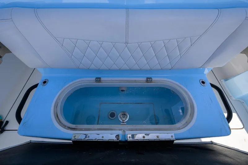  Yacht Photos Pics Livewell on 2022 Fountain 34 CC boat, featuring blue interior and cushioned seating.
