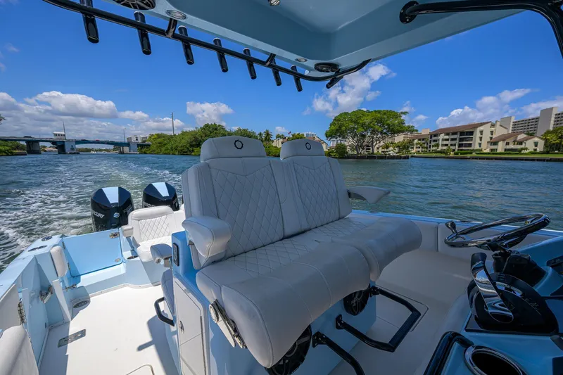  Yacht Photos Pics 2022 Fountain 34 CC boat interior with luxurious seating on a sunny day.