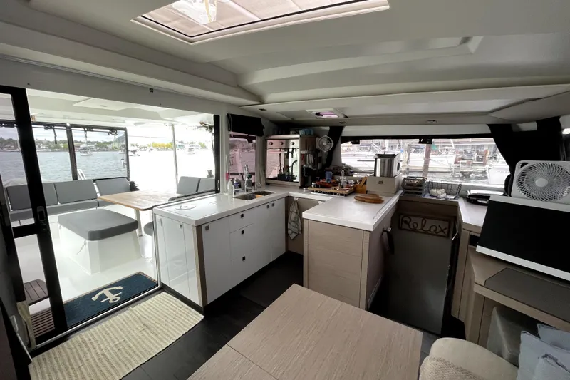 No Brainer Yacht Photos Pics Interior of 2022 Fountaine Pajot Catamaran Astrea 42, featuring modern kitchen and seating area.