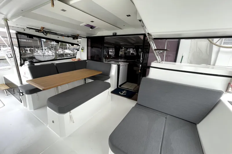 No Brainer Yacht Photos Pics Spacious interior of 2022 Fountaine Pajot Catamaran Astrea 42 with modern seating and dining area.