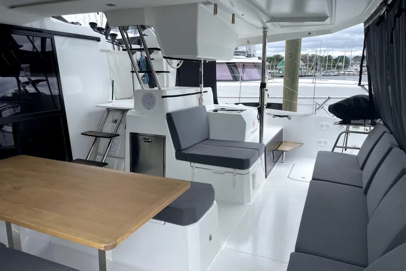 No Brainer Yacht Photos Pics 2022 Fountaine Pajot Catamaran Astrea 42 interior with seating and dining area.