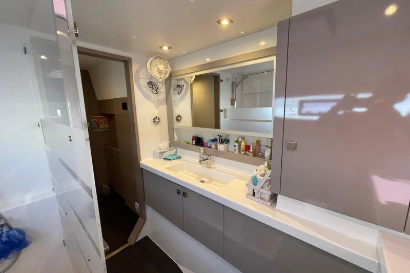 No Brainer Yacht Photos Pics Modern bathroom interior of 2022 Fountaine Pajot Catamaran Astrea 42 with sleek design and amenities.