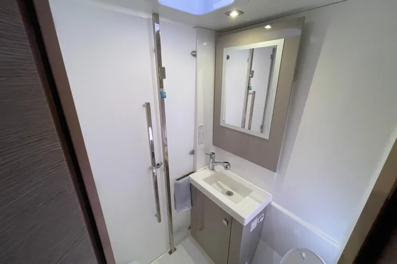 No Brainer Yacht Photos Pics Modern bathroom in 2022 Fountaine Pajot Catamaran Astrea 42, featuring sleek sink and mirror.
