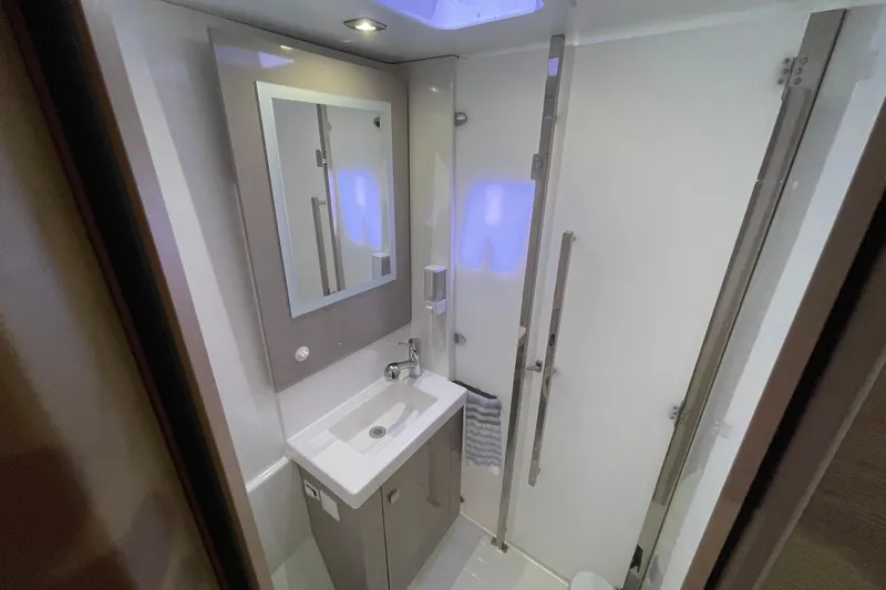 No Brainer Yacht Photos Pics Modern bathroom in 2022 Fountaine Pajot Catamaran Astrea 42, featuring sleek design and compact amenities.