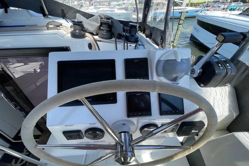 No Brainer Yacht Photos Pics Helm of 2022 Fountaine Pajot Catamaran Astrea 42 with navigation instruments and steering wheel.