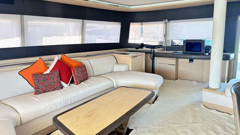  Yacht Photos Pics Luxurious interior of 2022 Lagoon 65 yacht with modern furnishings and vibrant cushions.