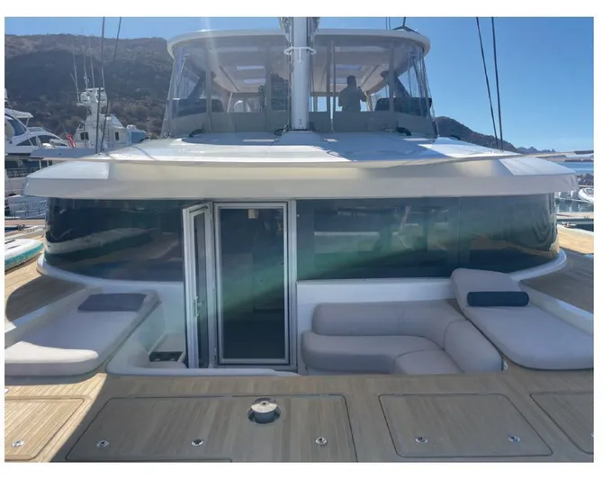  Yacht Photos Pics 2022 Lagoon 65 yacht with spacious deck and modern seating area.