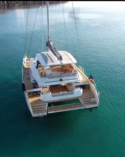  Yacht Photos Pics Luxury Lagoon 65 catamaran, 2022 model, anchored in clear turquoise waters.