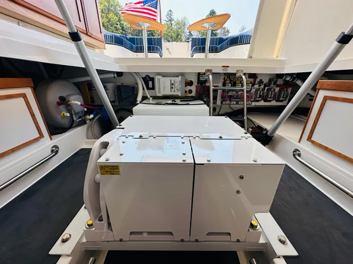 Mr. Sandman Yacht Photos Pics Engine compartment of 2023 Back Cove 34O boat, showcasing mechanical components and storage.
