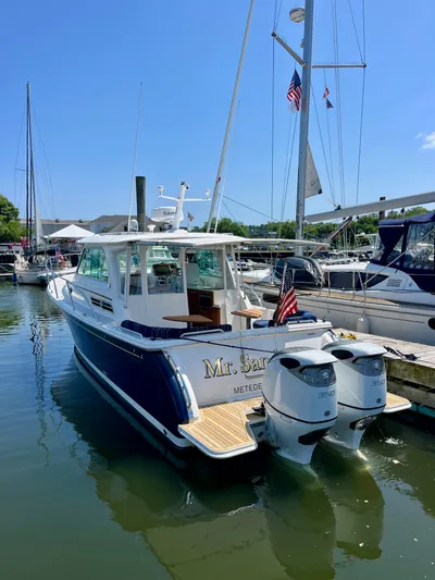 Mr. Sandman Yacht Photos Pics 2023 Back Cove 34O boat docked, featuring dual outboard engines and American flag.