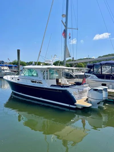 Mr. Sandman Yacht Photos Pics 2023 Back Cove 34O boat docked in a marina under a clear blue sky.