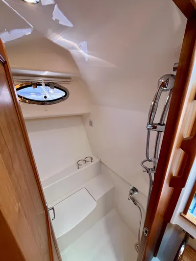 Mr. Sandman Yacht Photos Pics 2023 Back Cove 34O yacht bathroom with shower and porthole window.