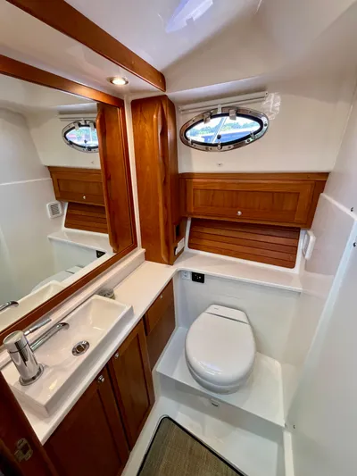 Mr. Sandman Yacht Photos Pics Luxurious bathroom in 2023 Back Cove 34O yacht, featuring wood accents and modern fixtures.