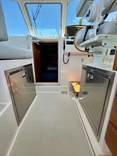 Mr. Sandman Yacht Photos Pics 2023 Back Cove 34O interior with modern helm and stainless steel appliances.