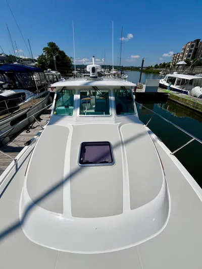 Mr. Sandman Yacht Photos Pics 2023 Back Cove 34O boat docked at marina under clear blue sky.
