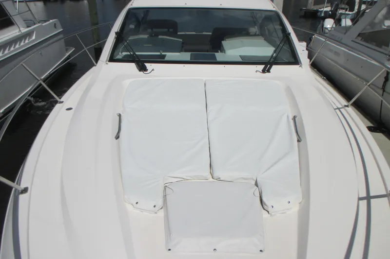 Worth Pursuit Yacht Photos Pics 2013 Pursuit SC 365i Sport Coupe boat with white deck cushions at marina.