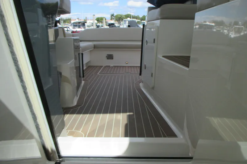 Worth Pursuit Yacht Photos Pics 2013 Pursuit SC 365i Sport Coupe interior with sleek design and wood-patterned flooring.
