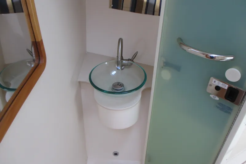 Worth Pursuit Yacht Photos Pics 2013 Pursuit SC 365i Sport Coupe bathroom with glass sink and modern fixtures.