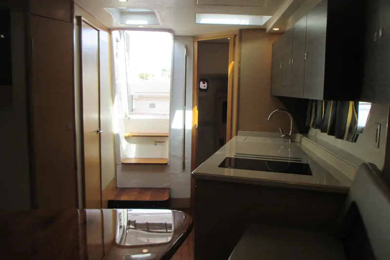 Worth Pursuit Yacht Photos Pics Interior of 2013 Pursuit SC 365i Sport Coupe, featuring modern kitchen and seating area.