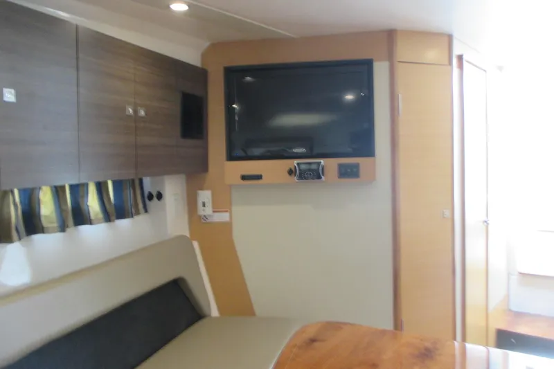 Worth Pursuit Yacht Photos Pics Interior of 2013 Pursuit SC 365i Sport Coupe with TV and seating area.