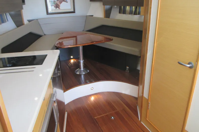 Worth Pursuit Yacht Photos Pics Interior of 2013 Pursuit SC 365i Sport Coupe with wood flooring and modern seating area.
