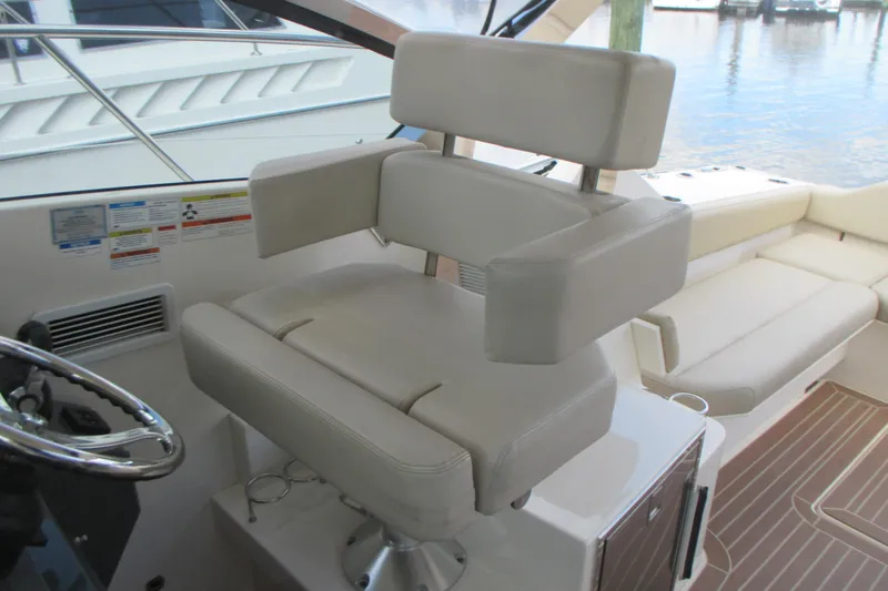 Worth Pursuit Yacht Photos Pics Captain's chair on 2013 Pursuit SC 365i Sport Coupe, featuring luxurious beige upholstery.