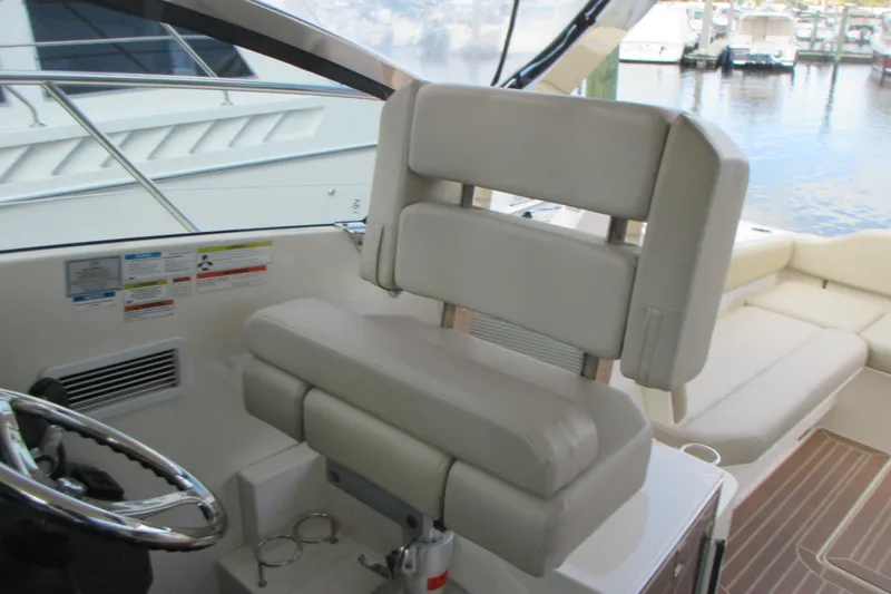 Worth Pursuit Yacht Photos Pics 2013 Pursuit SC 365i Sport Coupe helm seat and steering wheel, docked at marina.