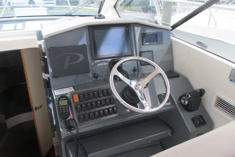 Worth Pursuit Yacht Photos Pics Cockpit of 2013 Pursuit SC 365i Sport Coupe with steering wheel and control panel.